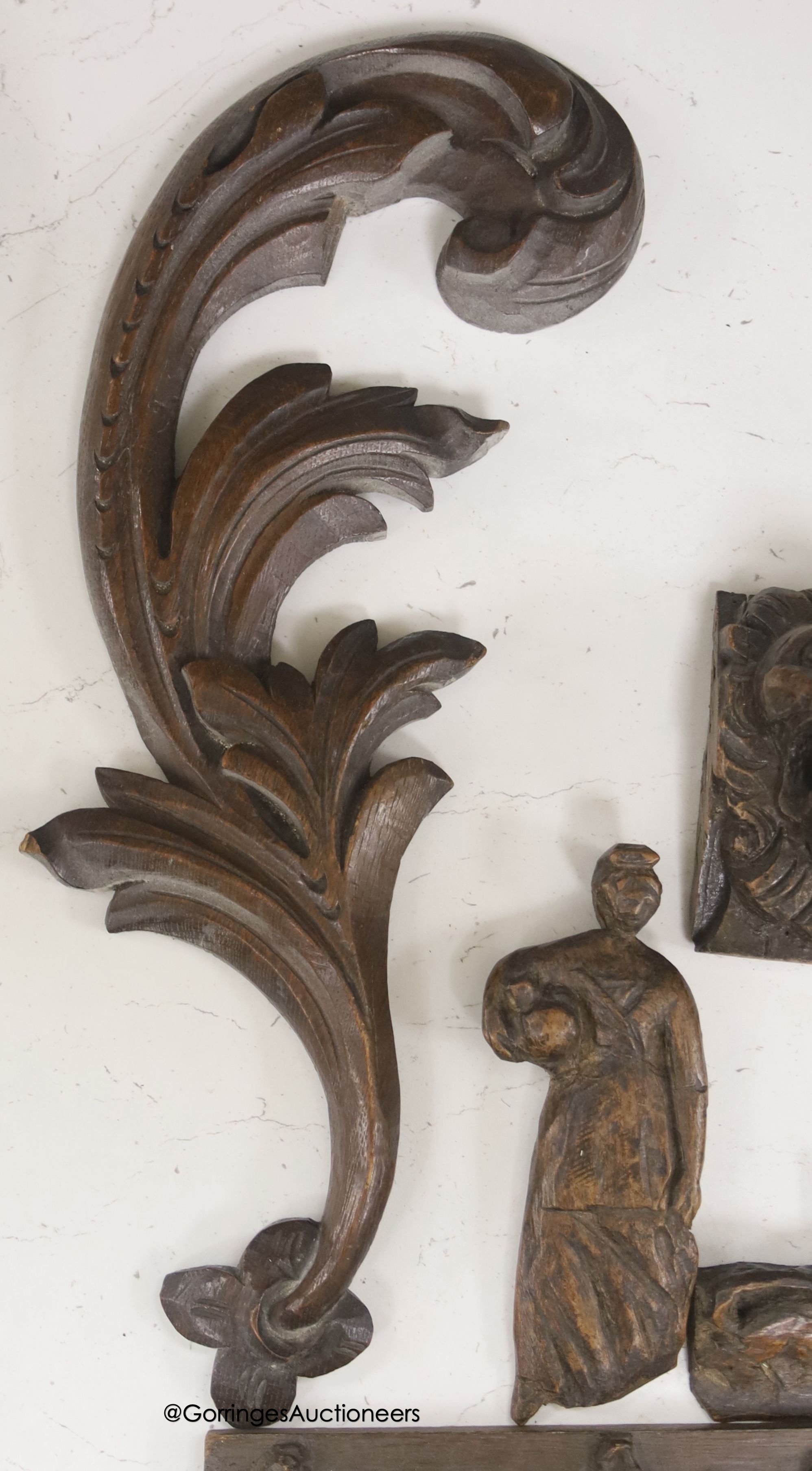 Seven 17th century or later carved oak fragments including a pair of lion masks